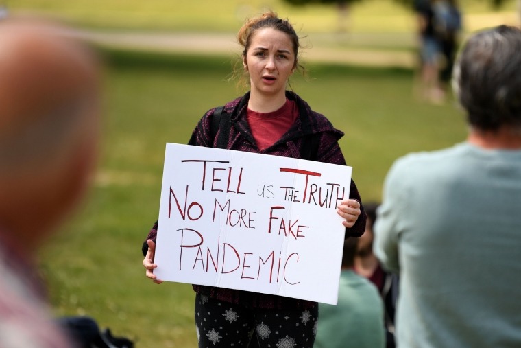 A woman holds a placard at an anti-coronavirus lockdown demonstration in Hyde Park in London on May 16, 2020, following an easing of lockdown rules in England during the novel coronavirus COVID-19 pandemic. - Fliers advertising 'mass gatherings' organised by the UK Freedom Movement to oppose the government lockdown measures and guidelines put in place to halt the spread of coronavirus in parks around the UK calling for attendees to bring a picnic and music have been circulating on social media. (Photo by DANIEL LEAL-OLIVAS / AFP) (Photo by DANIEL LEAL-OLIVAS/AFP via Getty Images)