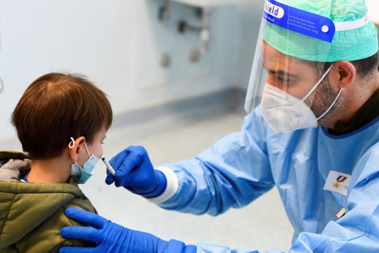 A military doctor administers a flu vaccine to a child in a military hospital after health authorities advised people to take a flu vaccine to avoid confusion with the coronavirus disease (COVID-19) symptoms, in Milan, Italy, November 20, 2020. REUTERS/Flavio Lo Scalzo