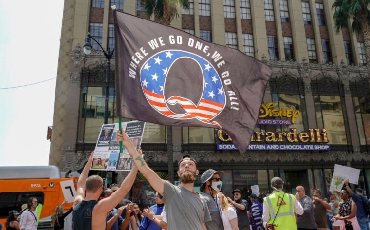 (FILES) In this file photo conspiracy theorist QAnon demonstrators protest child trafficking on Hollywood Boulevard in Los Angeles, California, August 22, 2020. - On January 11 Twitter announced it has suspended "more than 70,000 accounts" linked to the QAnon conspiracy theory following the attack on the US Capitol by a mob of President Donald Trump's supporters. "Given the violent events in Washington, DC, and increased risk of harm, we began permanently suspending thousands of accounts that were primarily dedicated to sharing QAnon content on Friday afternoon," Twitter said in a blog post. (Photo by Kyle Grillot / AFP) (Photo by KYLE GRILLOT/AFP via Getty Images)