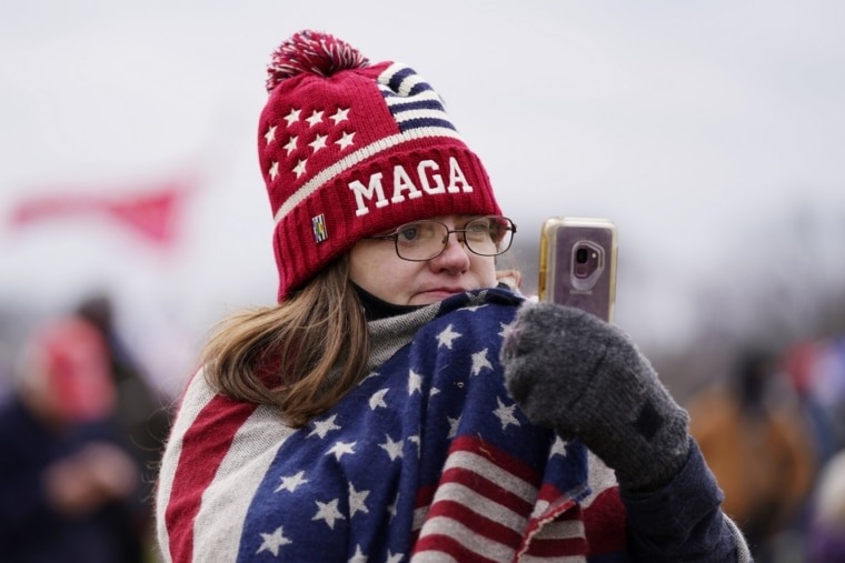 FILE - In this Jan. 6, 2021, file photo, a Trump supporter participates in a rally in Washington. Online supporters of Trump are scattering to smaller social media platforms, fleeing what they say is unfair treatment by Facebook, Twitter and other big tech firms looking to squelch misinformation and threats of violence. (AP Photo/Julio Cortez, File)